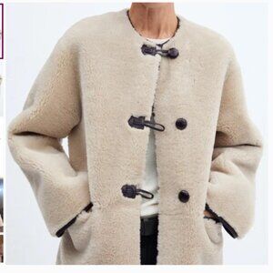 Mango Fur-effect coat with appliqués